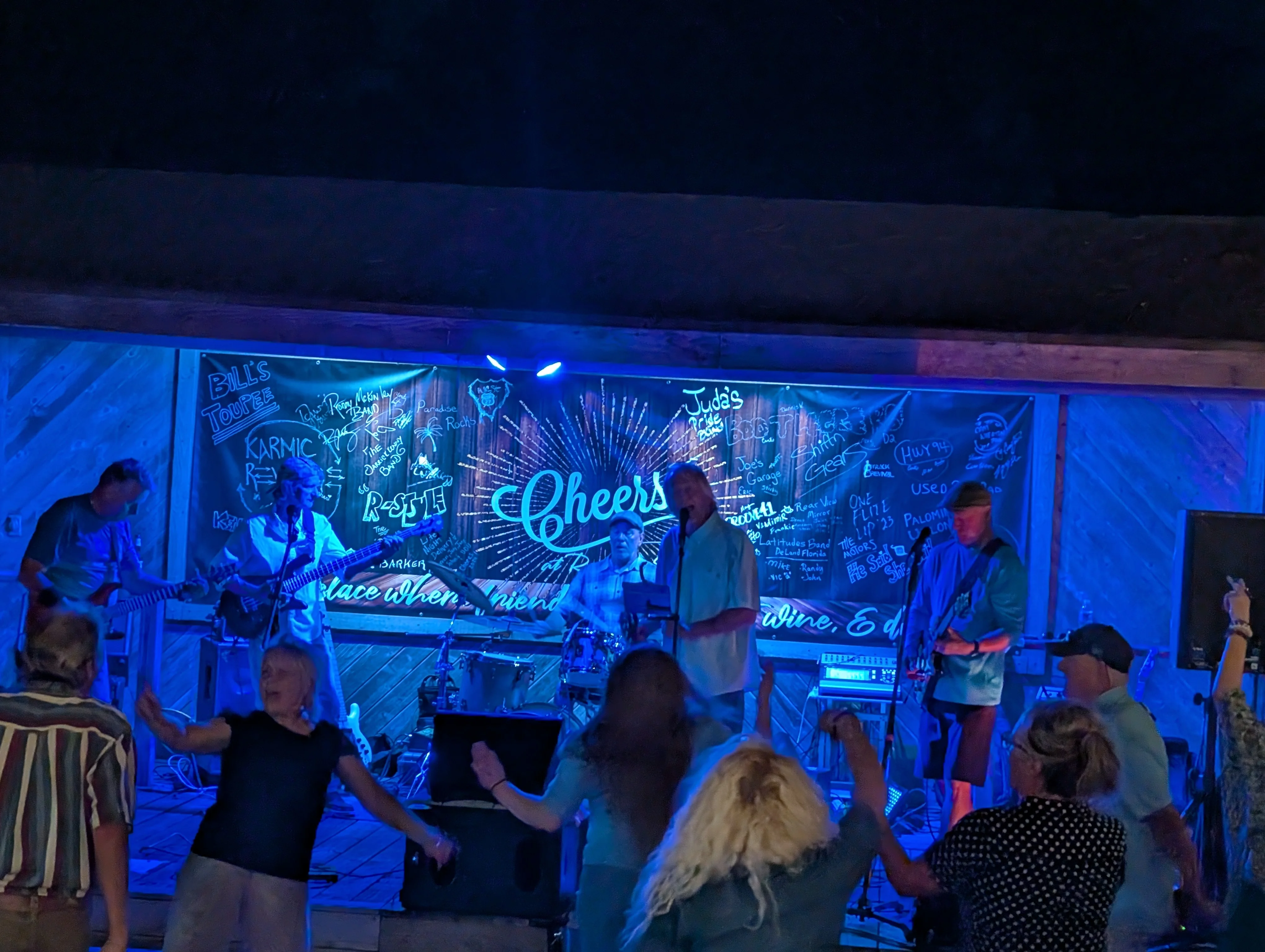 A lively band performing at a restaurant with vibrant atmosphere.