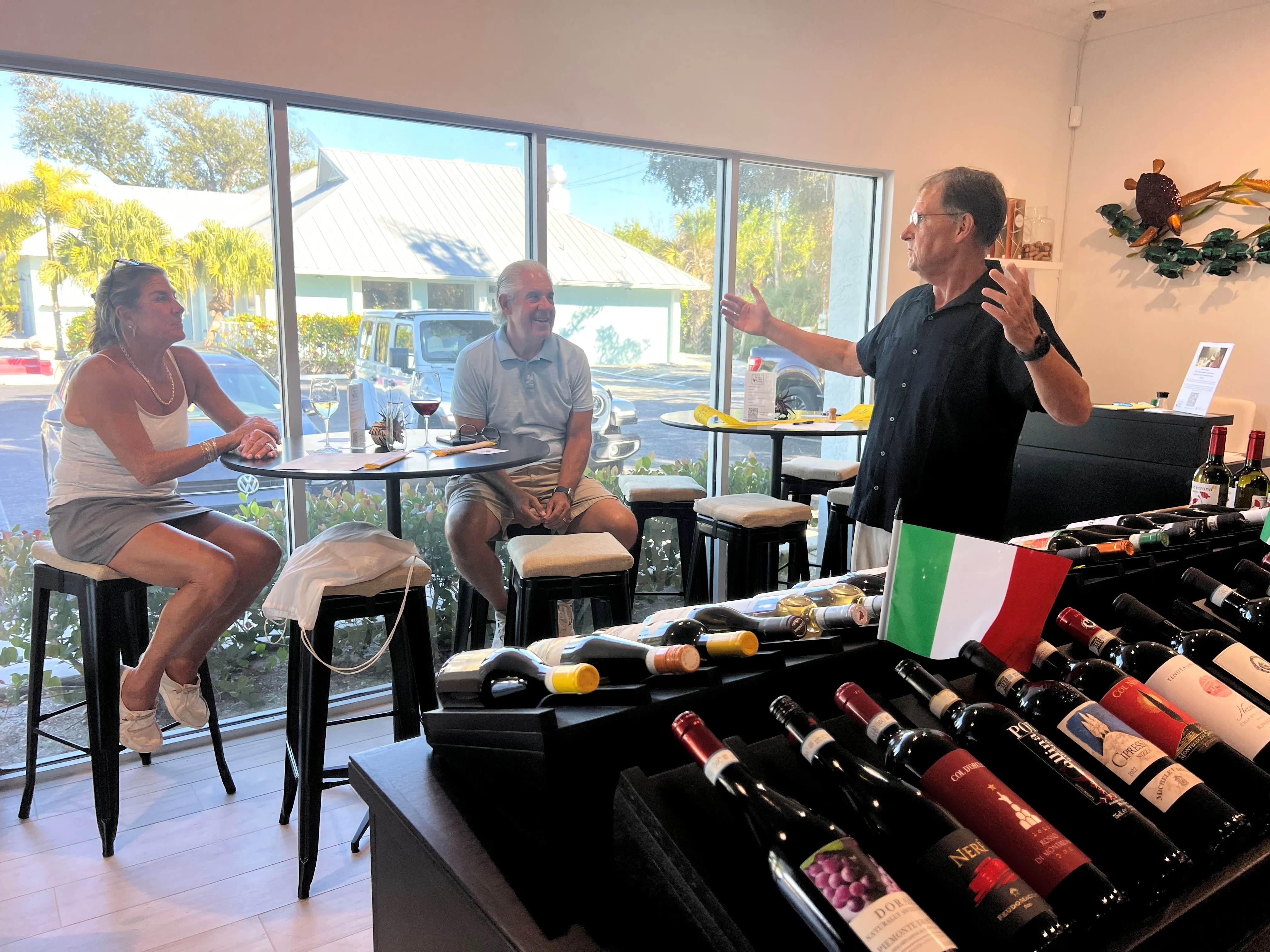 Guests enjoying wine and conversation in a cozy restaurant setting.