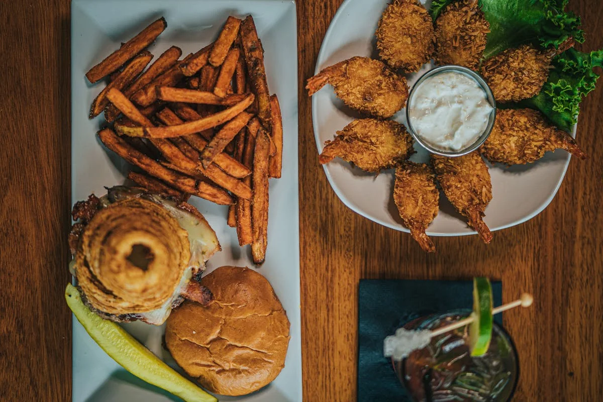 Crispy fried shrimp and a gourmet burger with sweet potato fries
