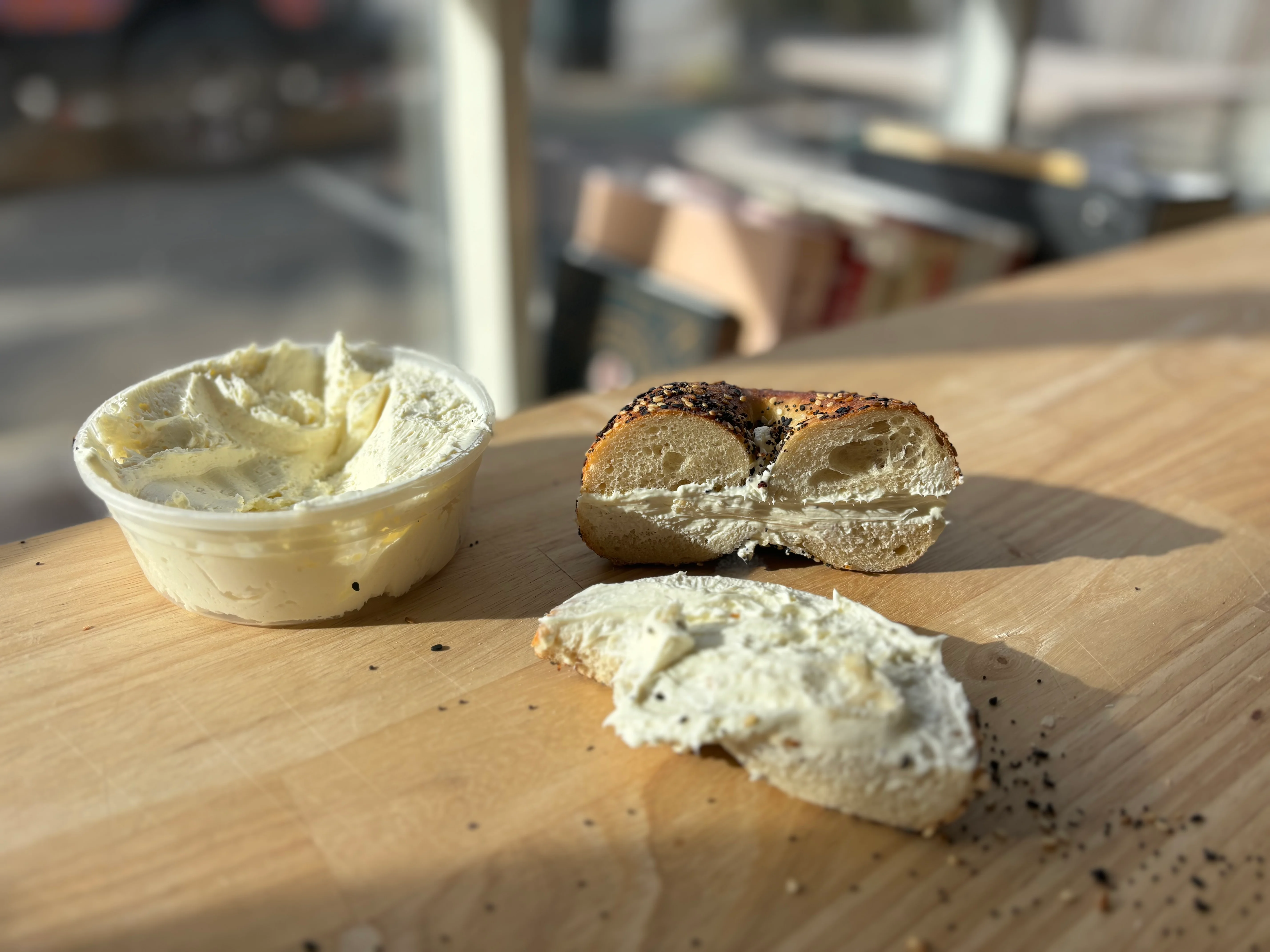 Bagel with cream cheese on a wooden table