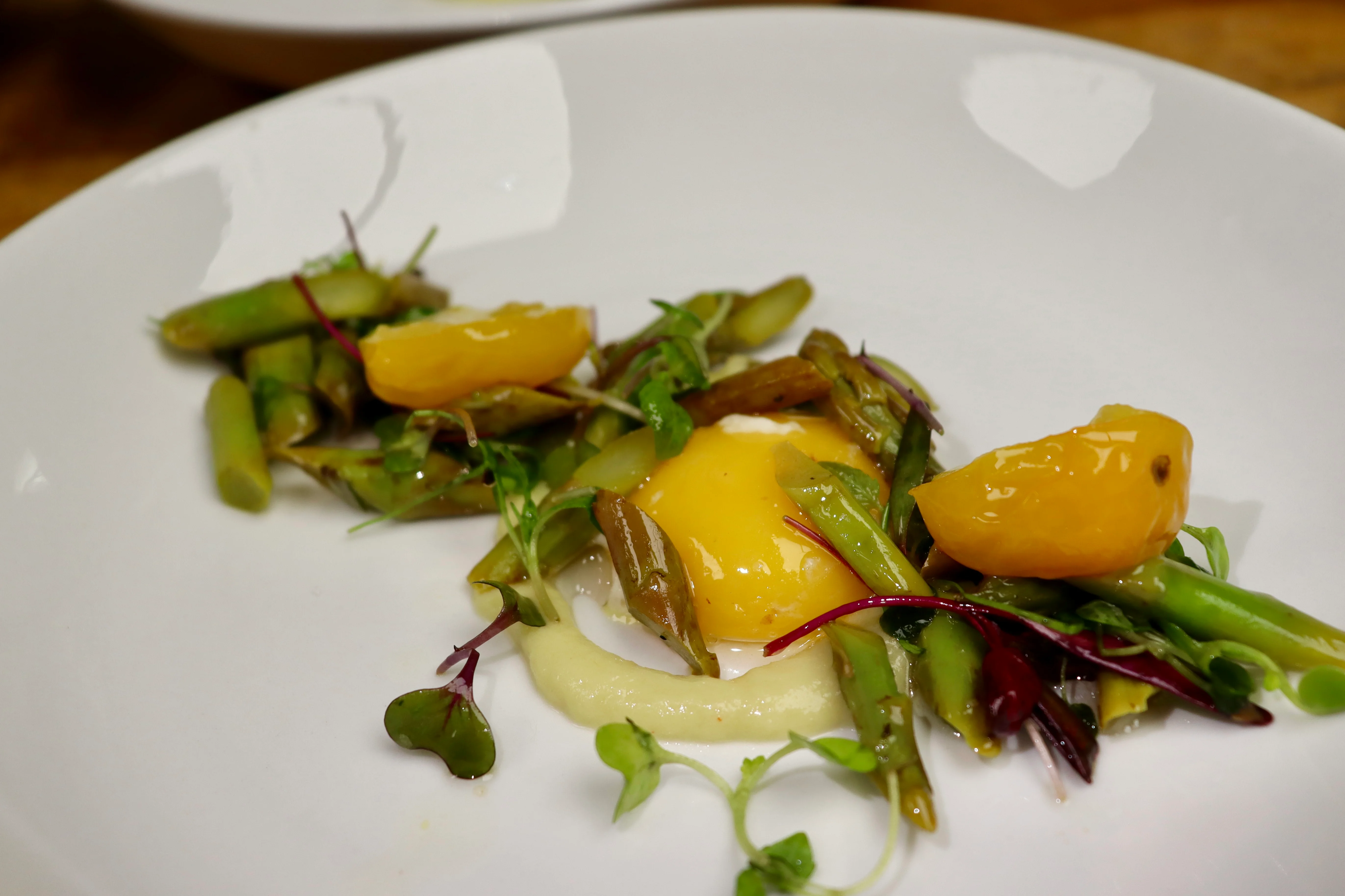 Artistic presentation of French asparagus salad with egg yolk