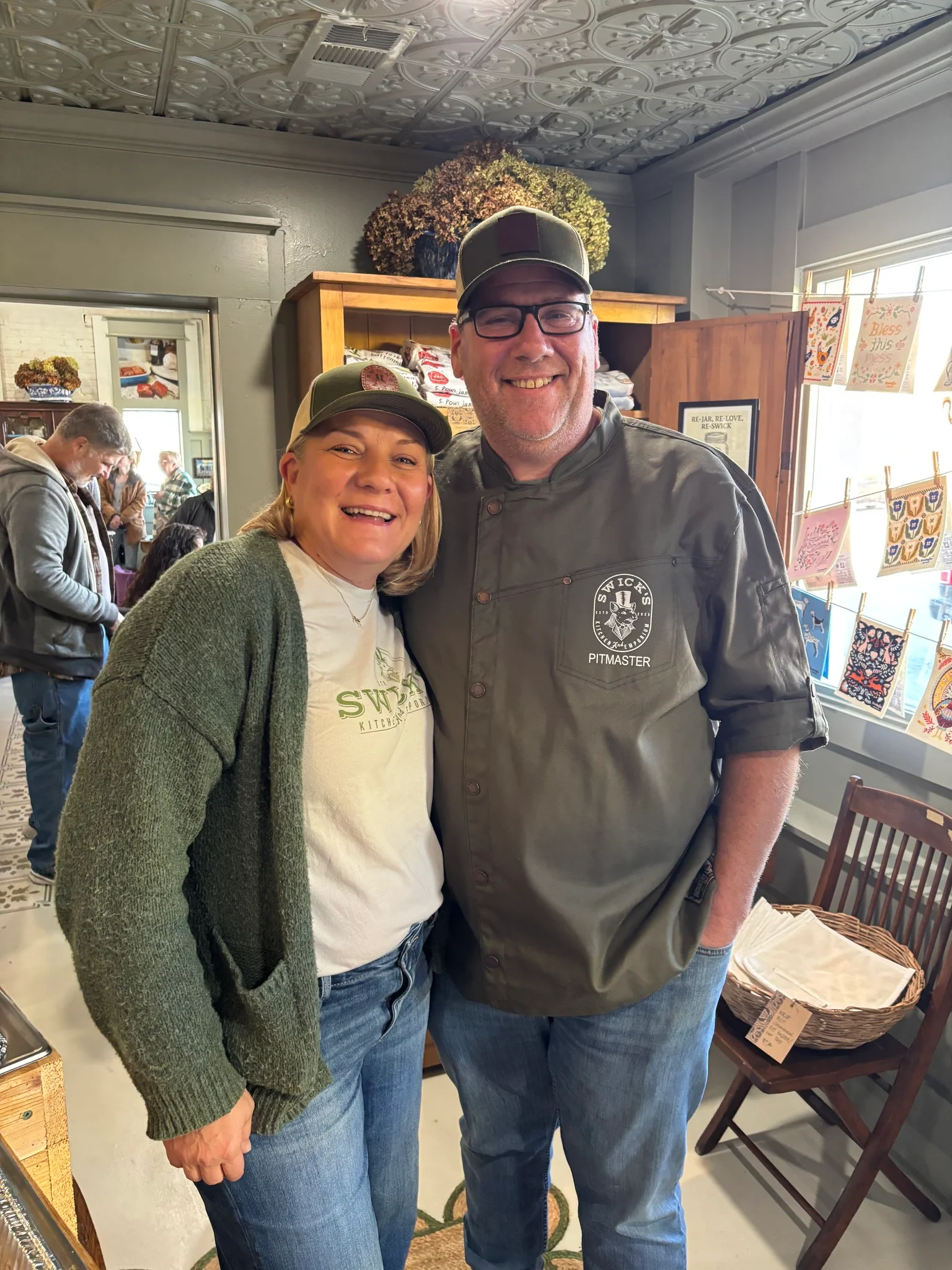 Two smiling individuals in a cozy restaurant setting