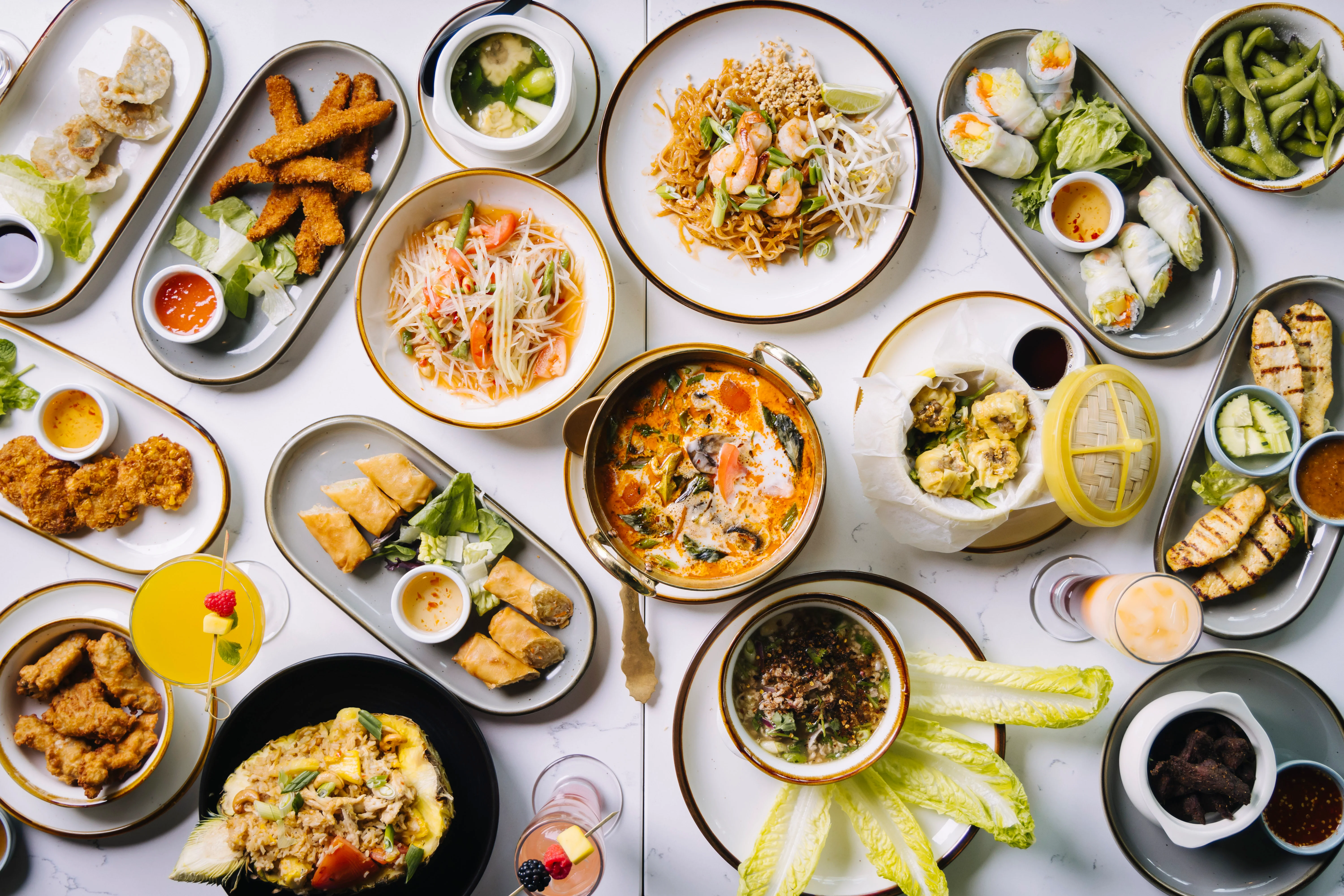 Assorted Thai dishes including pad thai and tom yum soup