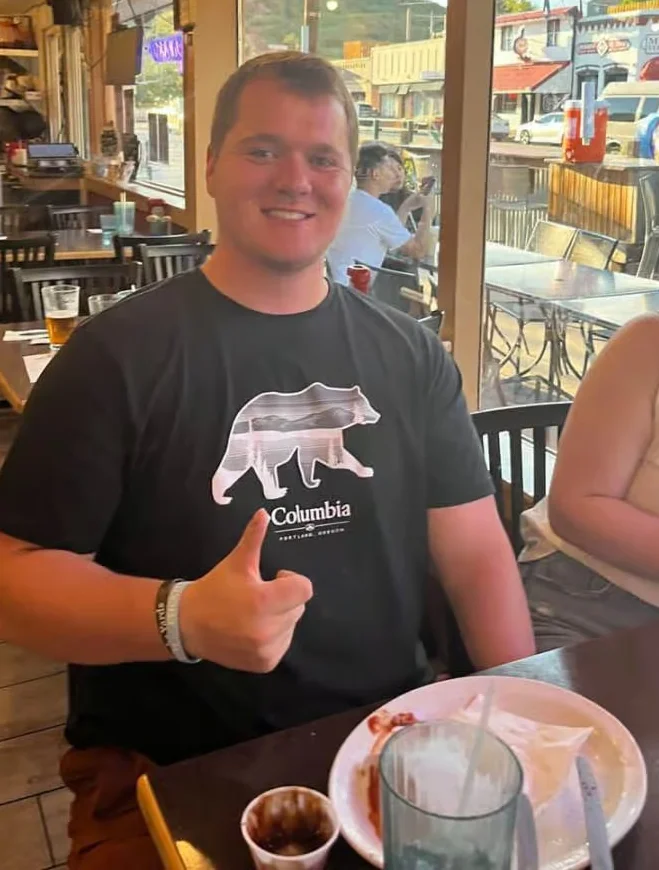 Happy diner giving a thumbs up in a cozy restaurant setting