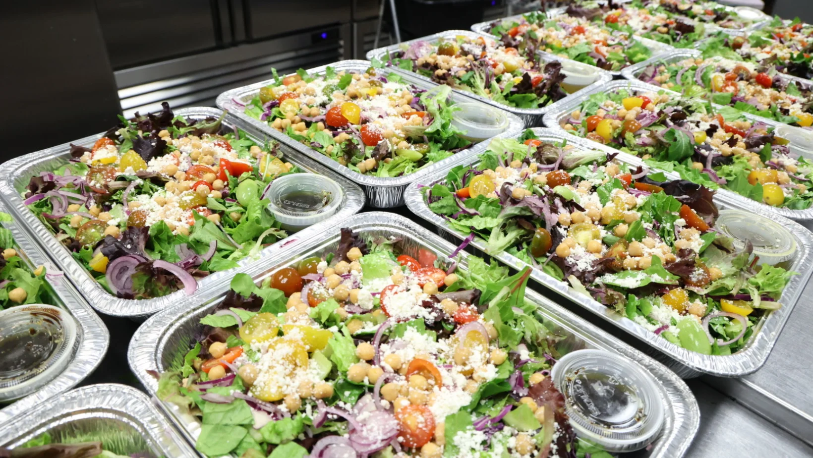 Fresh Mediterranean salad in aluminum trays