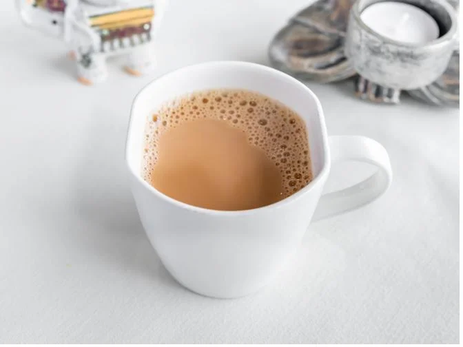 Cup of Indian chai tea with frothy milk