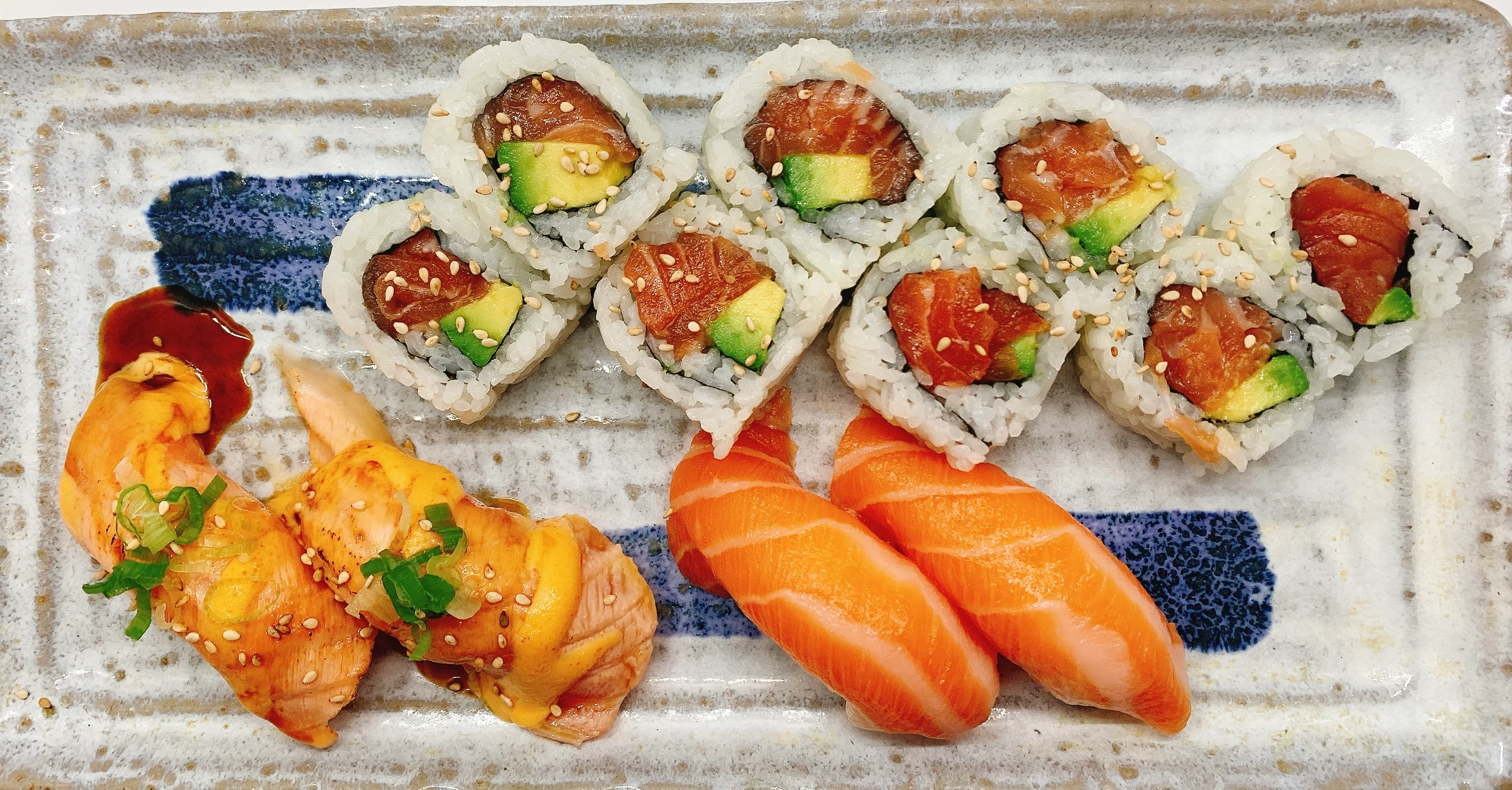Assorted sushi platter featuring nigiri and rolls