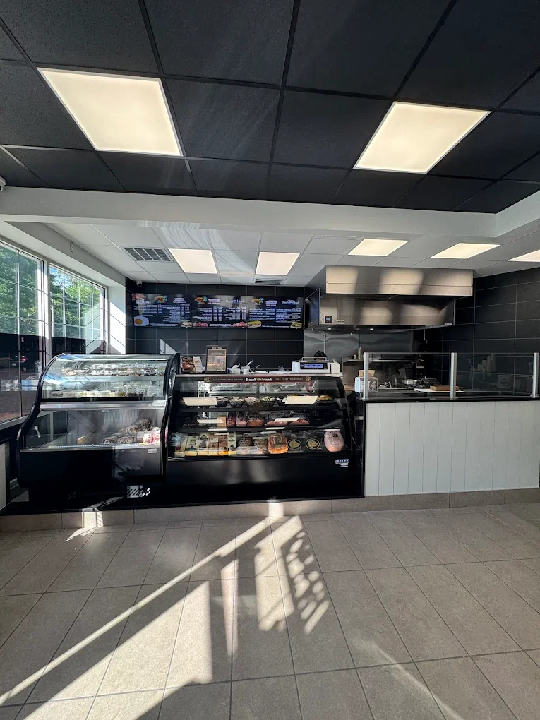 Modern restaurant interior with display case and menu board