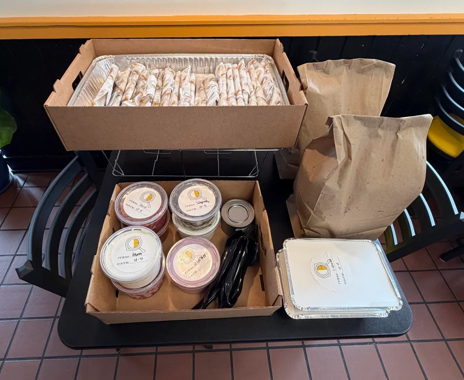Catering setup with assorted wraps and sauces in a restaurant