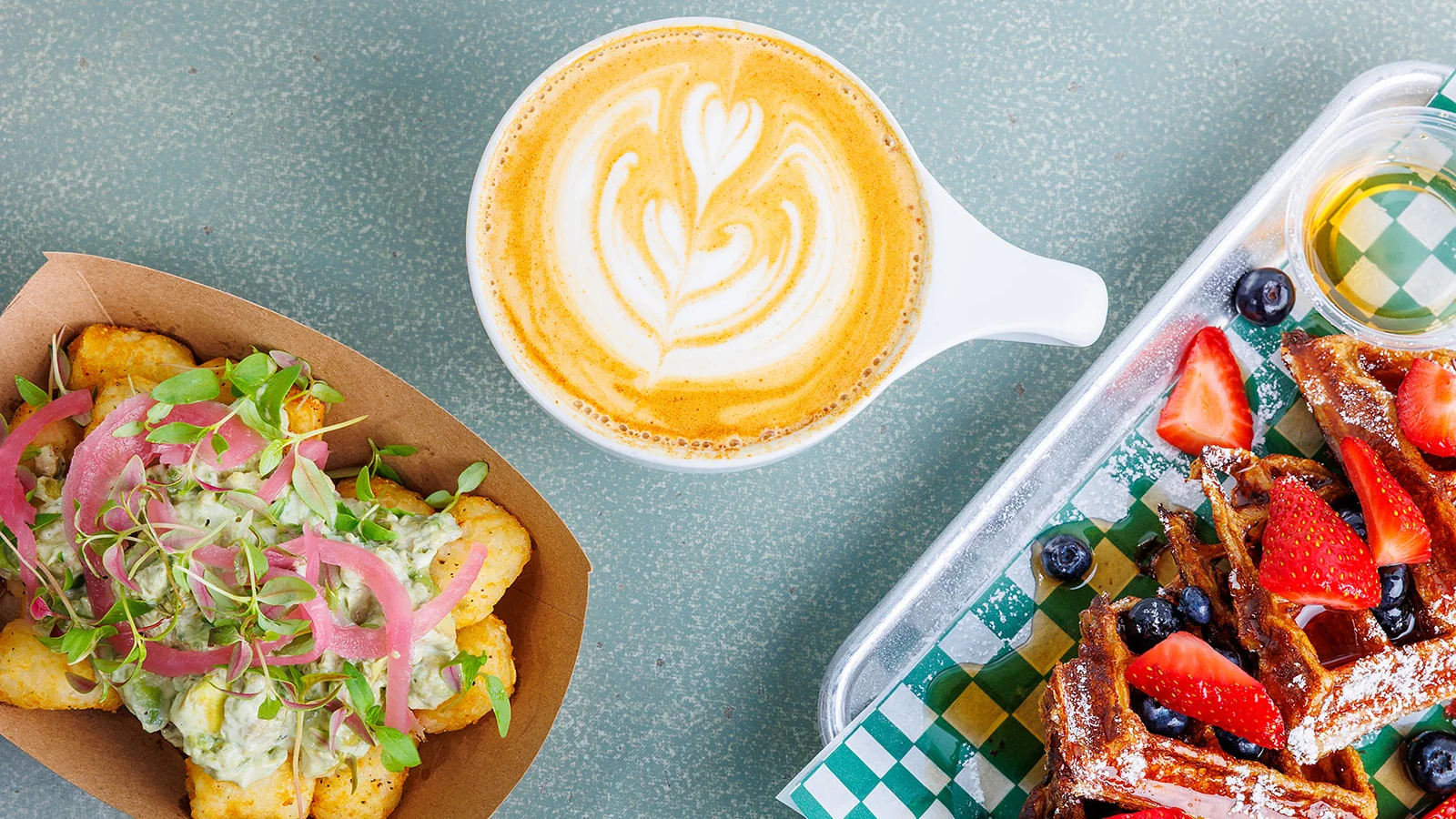 Delicious brunch featuring loaded tater tots and a latte art coffee