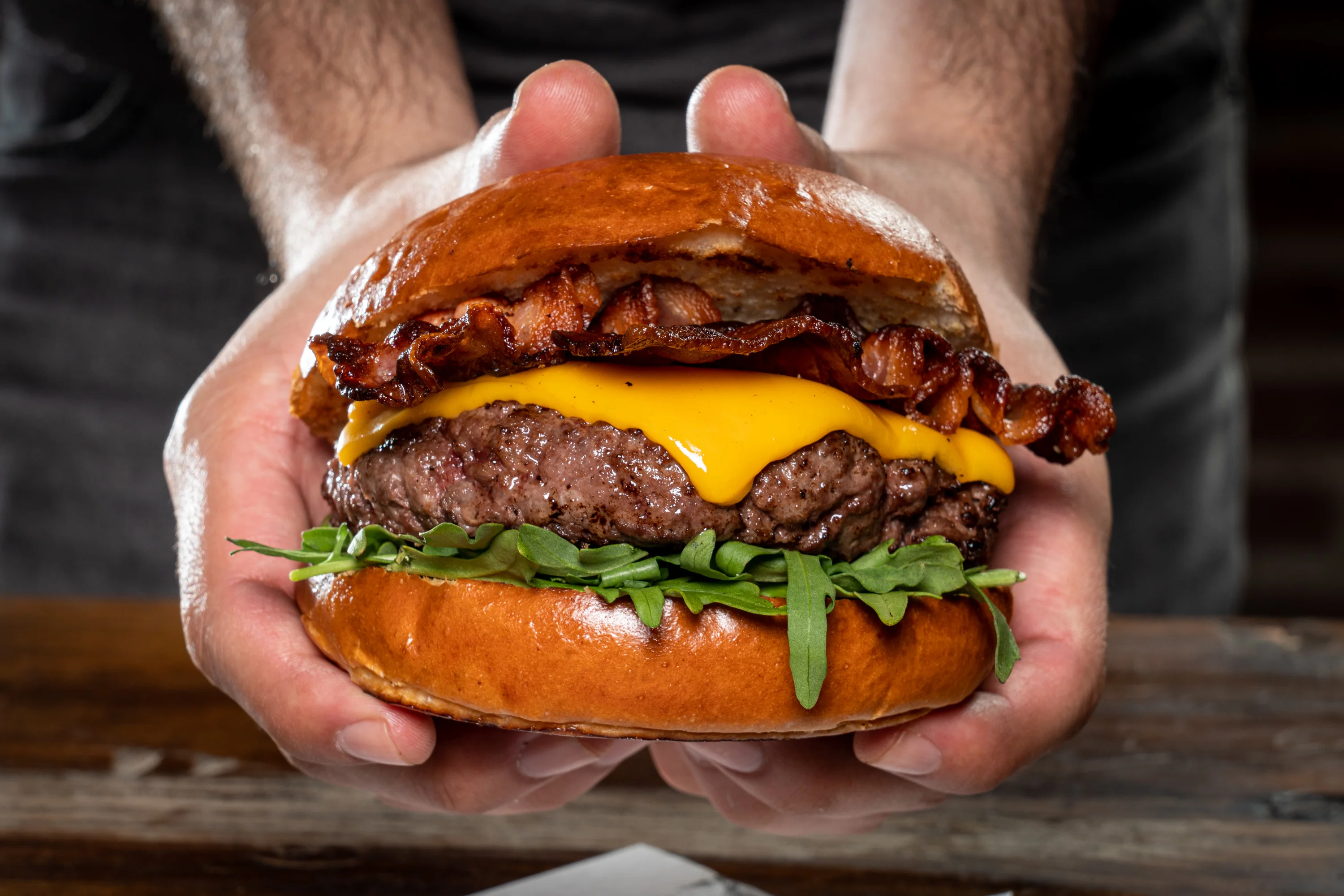 Juicy cheeseburger with bacon and arugula