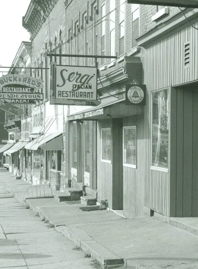 Historic street view with restaurant signs and shops