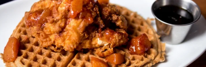 Southern chicken and waffles with syrup and caramelized apples