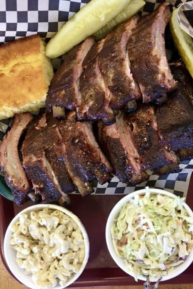 Smoked barbecue ribs with sides of coleslaw and macaroni salad