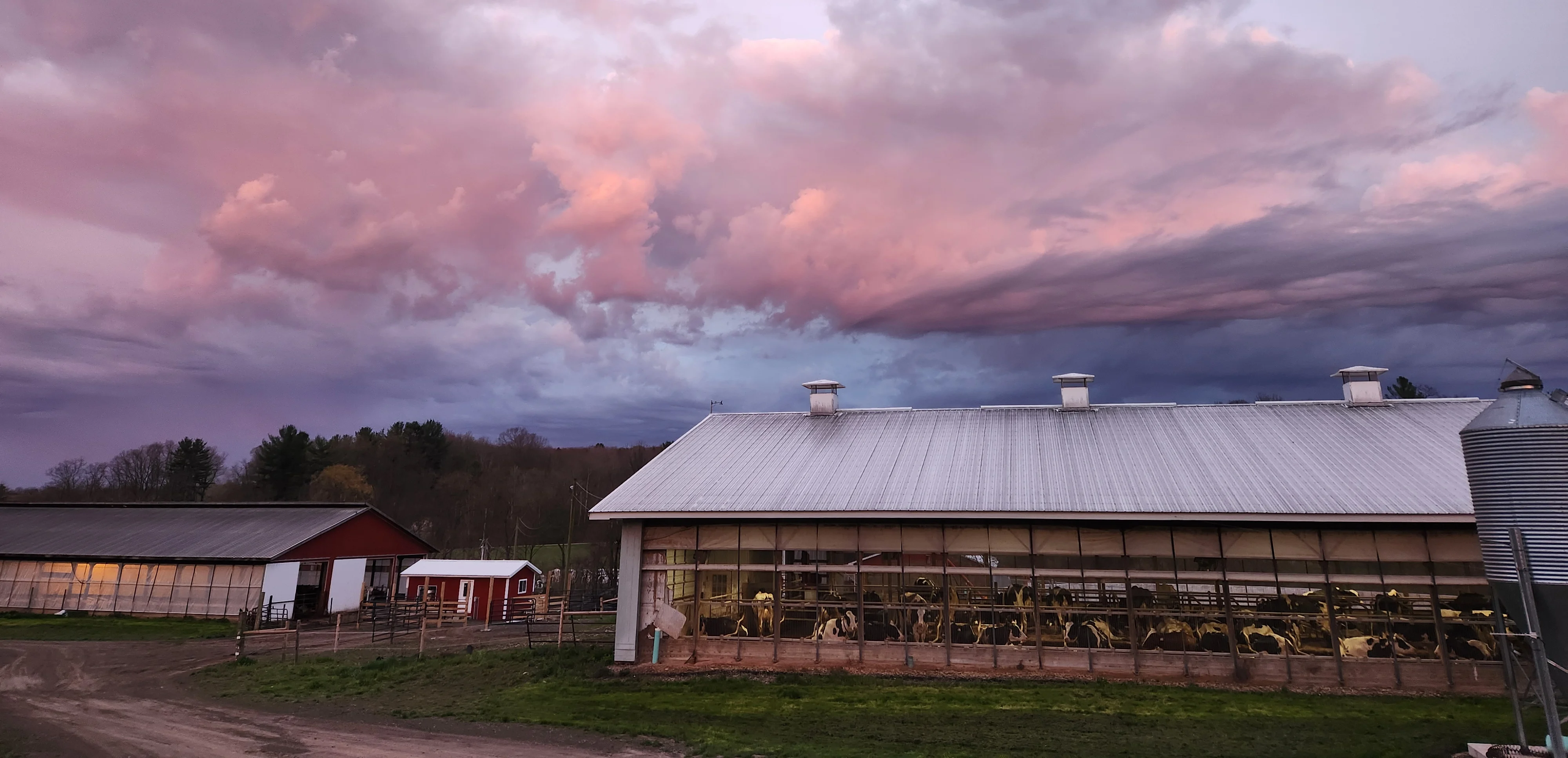 Scenic farm landscape at sunset with colorful clouds
