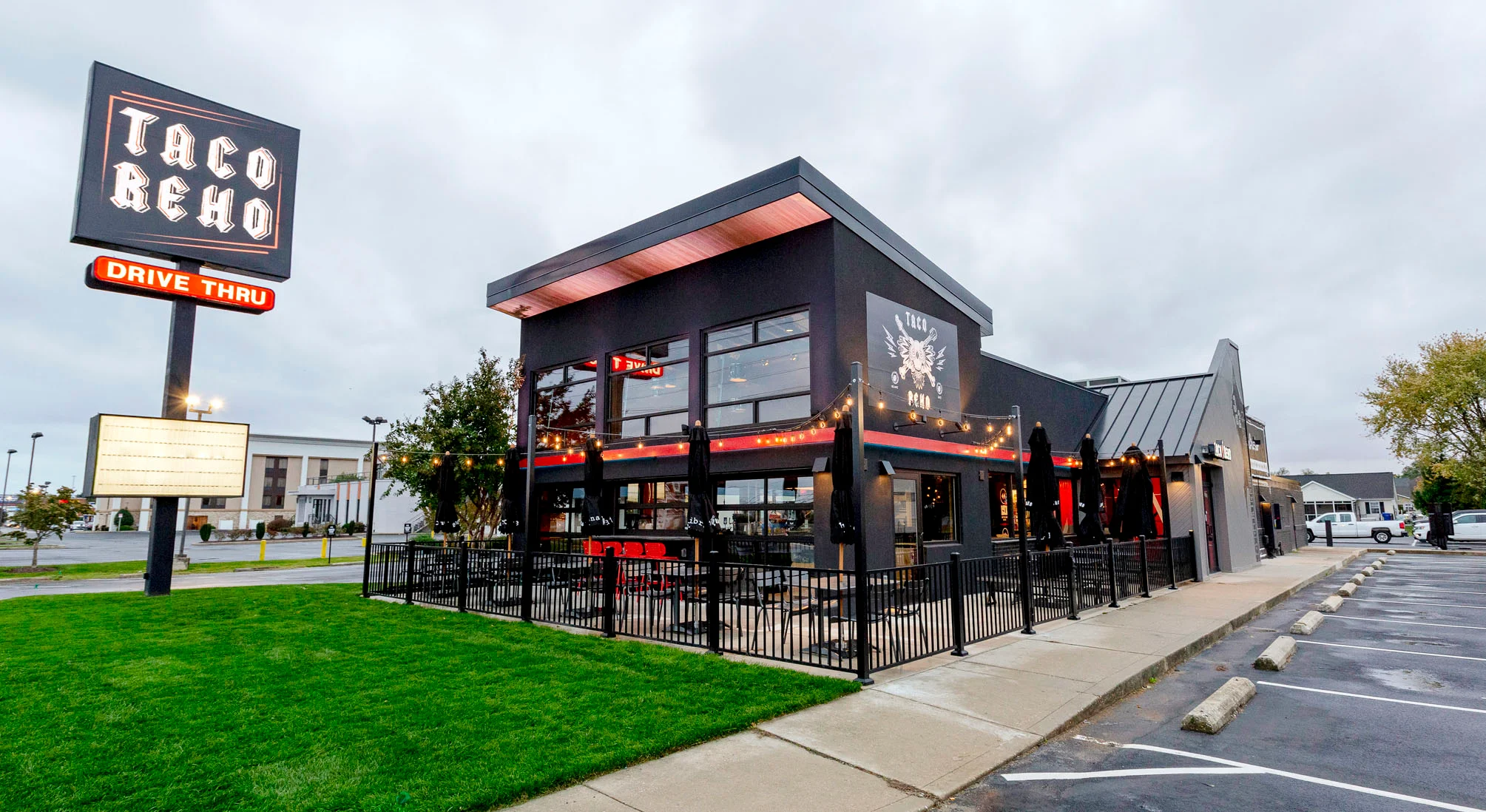 Modern taco restaurant exterior with drive-thru