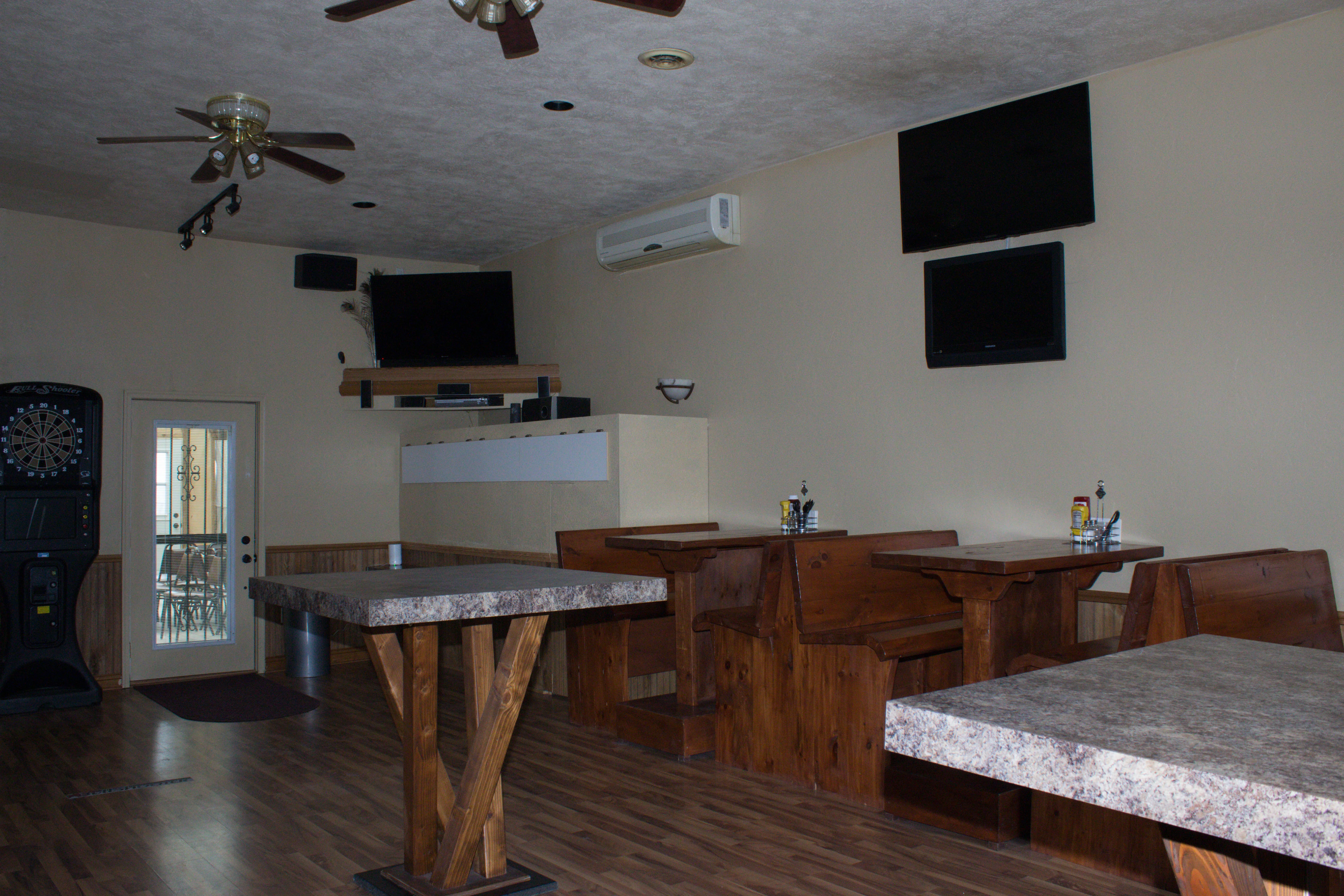 Cozy restaurant interior with wooden seating and dartboard