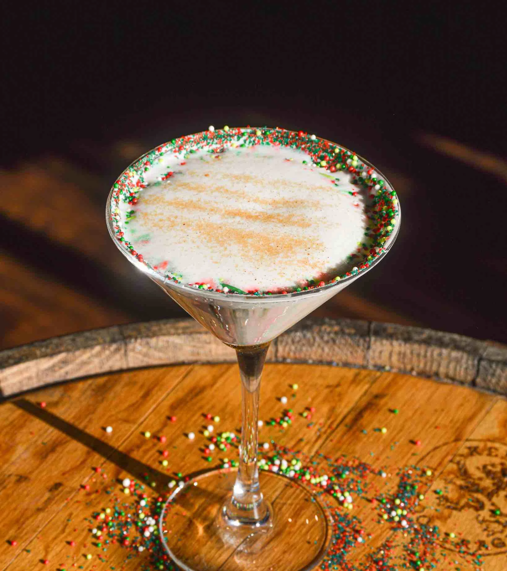 Sugar Cookie Martini surrounded by red and green holiday sprinkles
