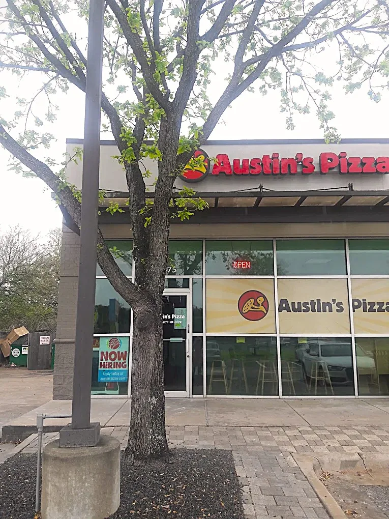 Exterior view of Austin's Pizza restaurant with open sign