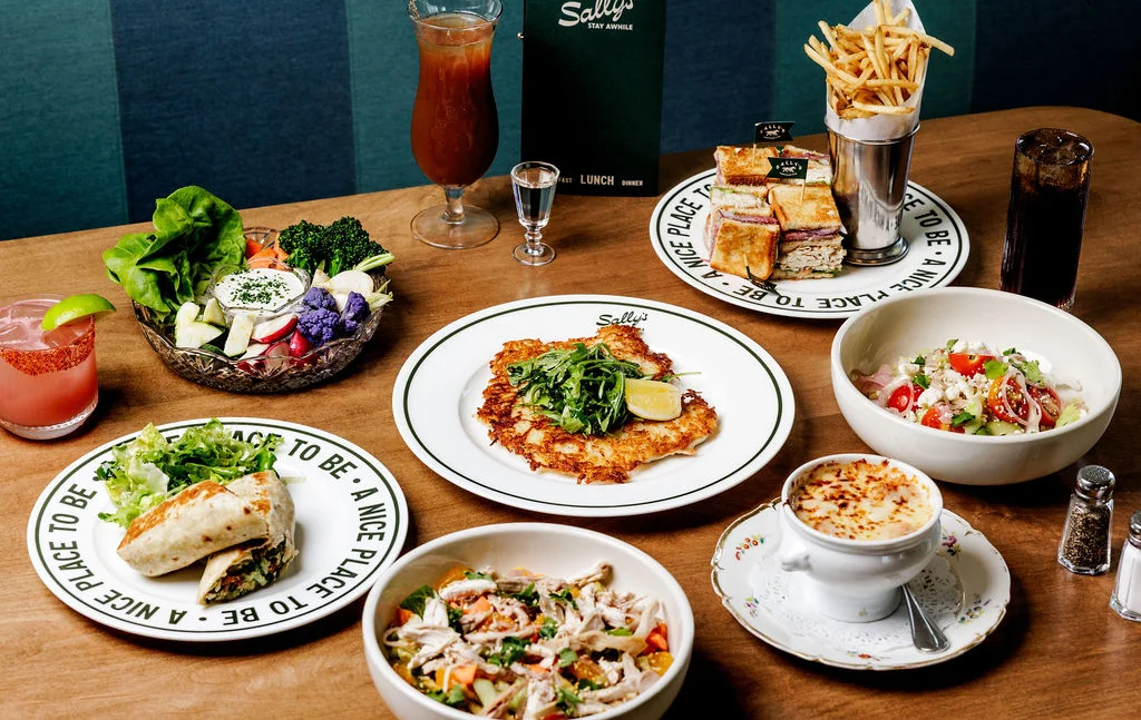 Assorted American dishes including salmon, fried chicken, and steak frites