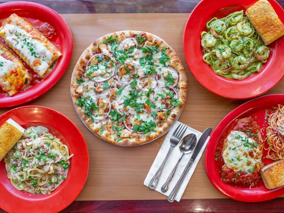 Italian feast featuring pizza, pasta, and enchiladas