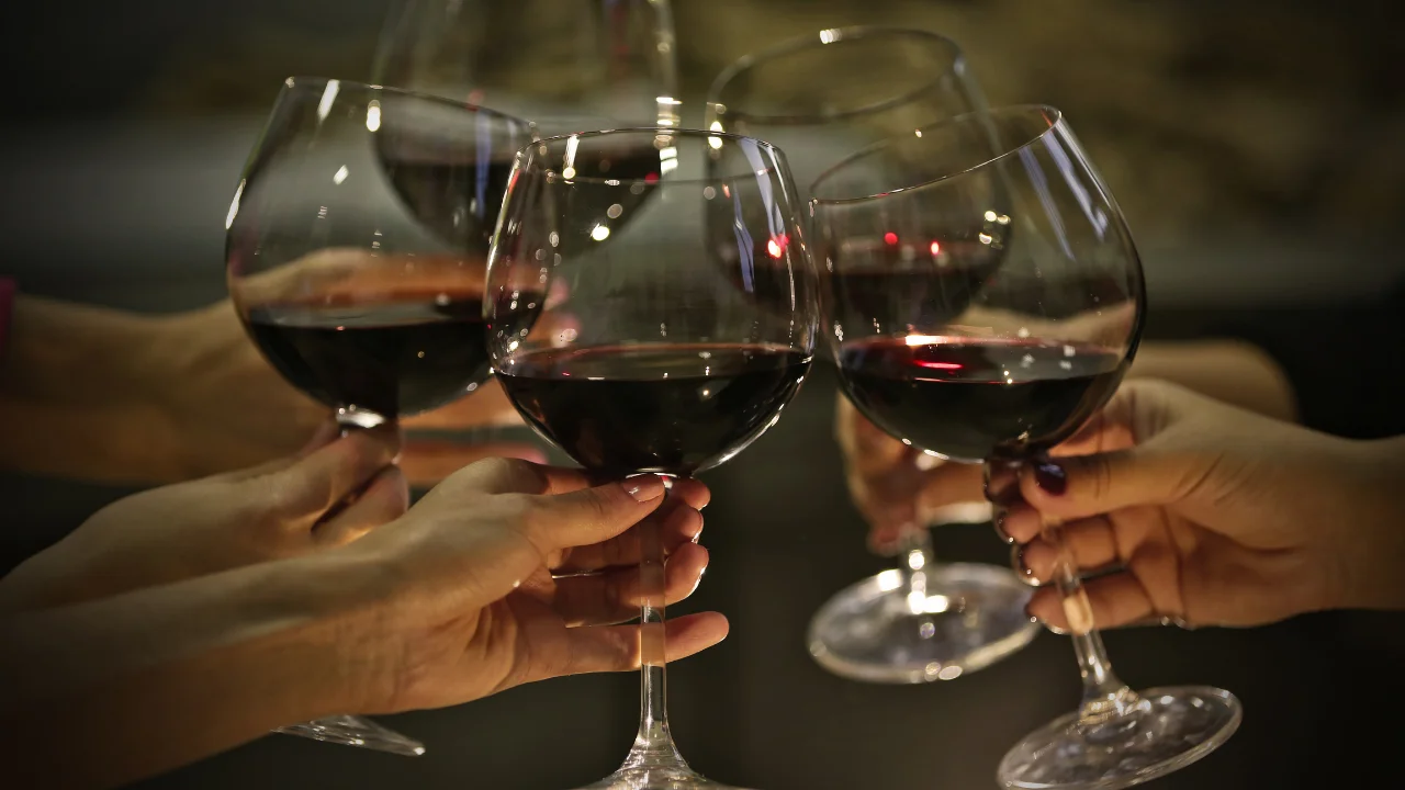 Cheers with red wine glasses in celebration