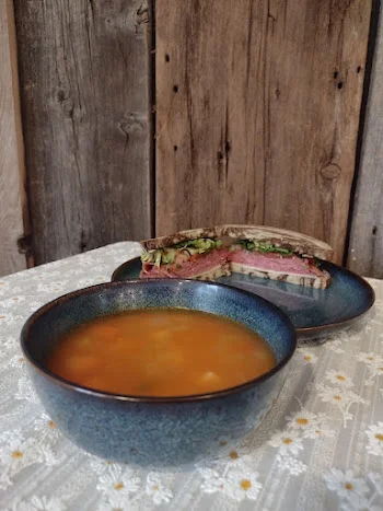 Hearty bowl of Italian minestrone soup with a side of sandwich