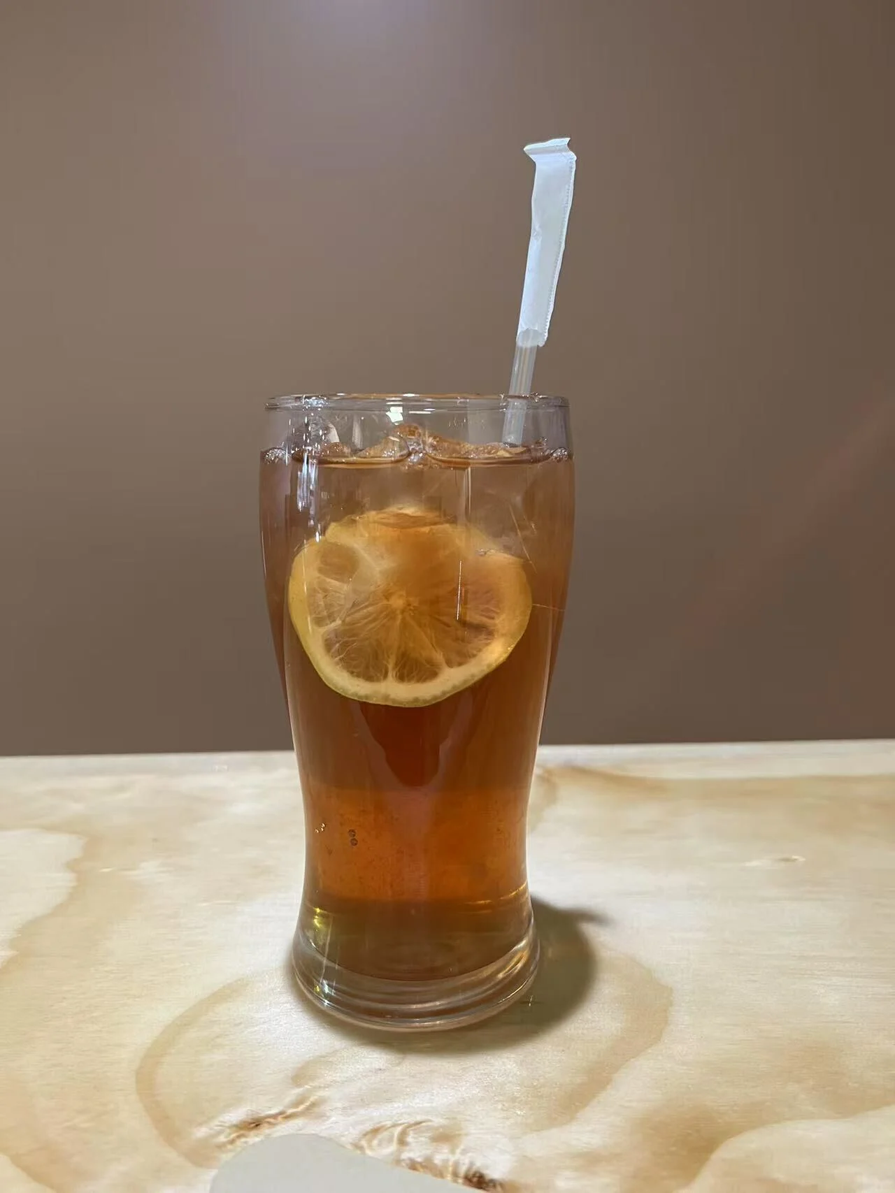 Refreshing iced tea with lemon slice in a glass