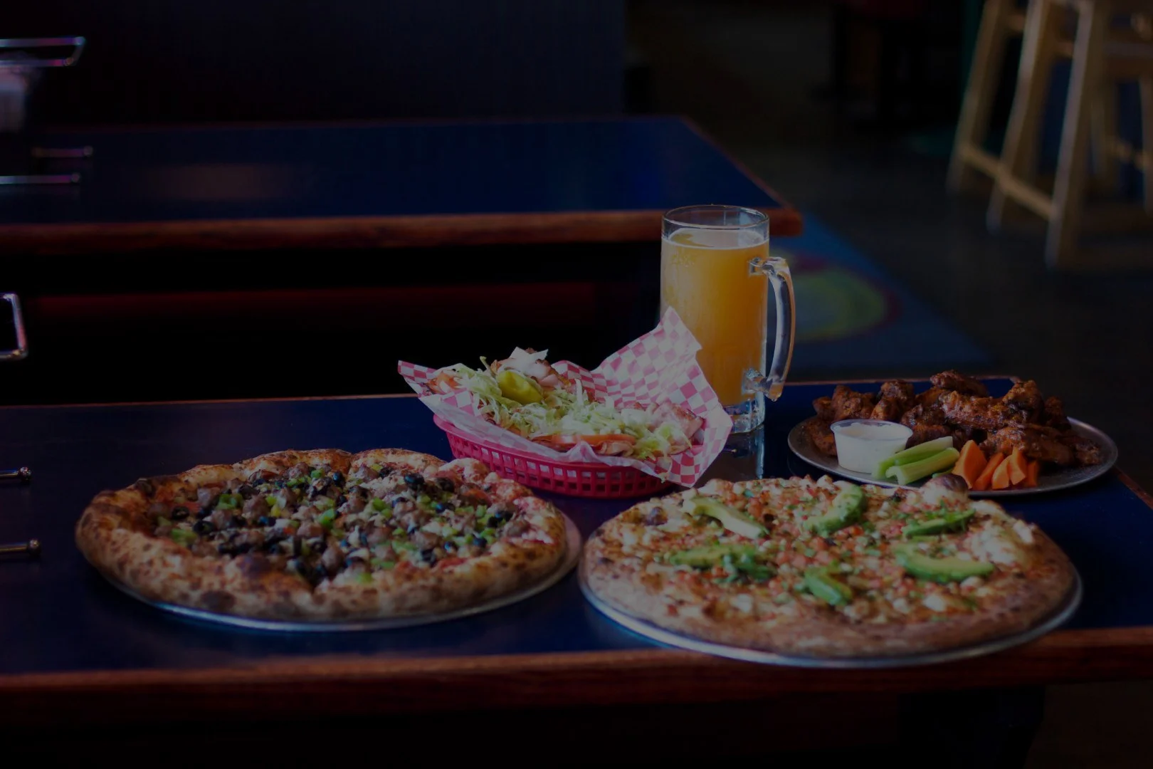 Pizzas, wings and drinks on a team party table at Stadium Pepz Pizza & Eatery in Anaheim