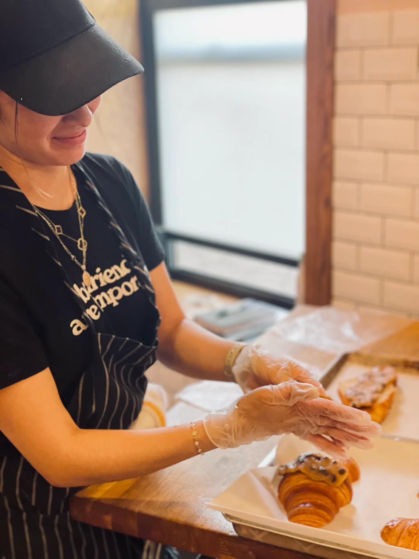 Baker preparing fresh pastries in a cozy café
