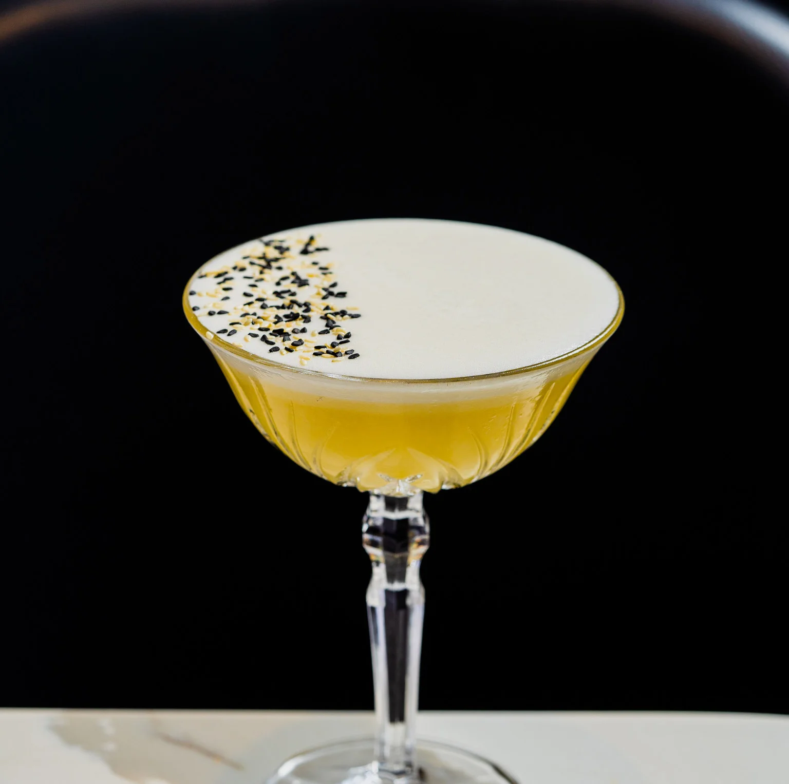 Sesame Oil-Washed Gin, Ginger, Coconut, Palm Sugar, Egg White, Lemon, Lime, Sesame Seeds