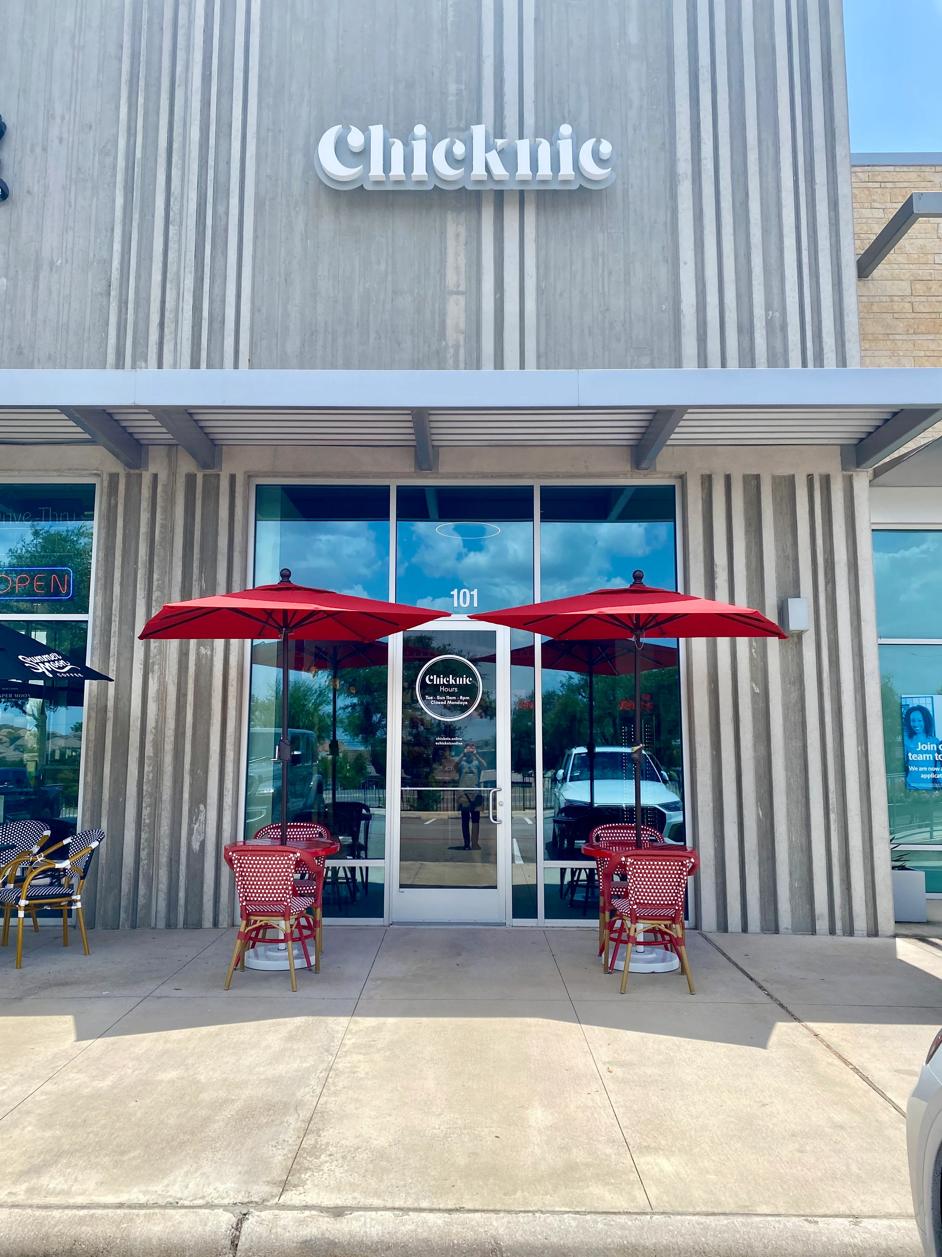Charming restaurant entrance with outdoor seating and umbrellas