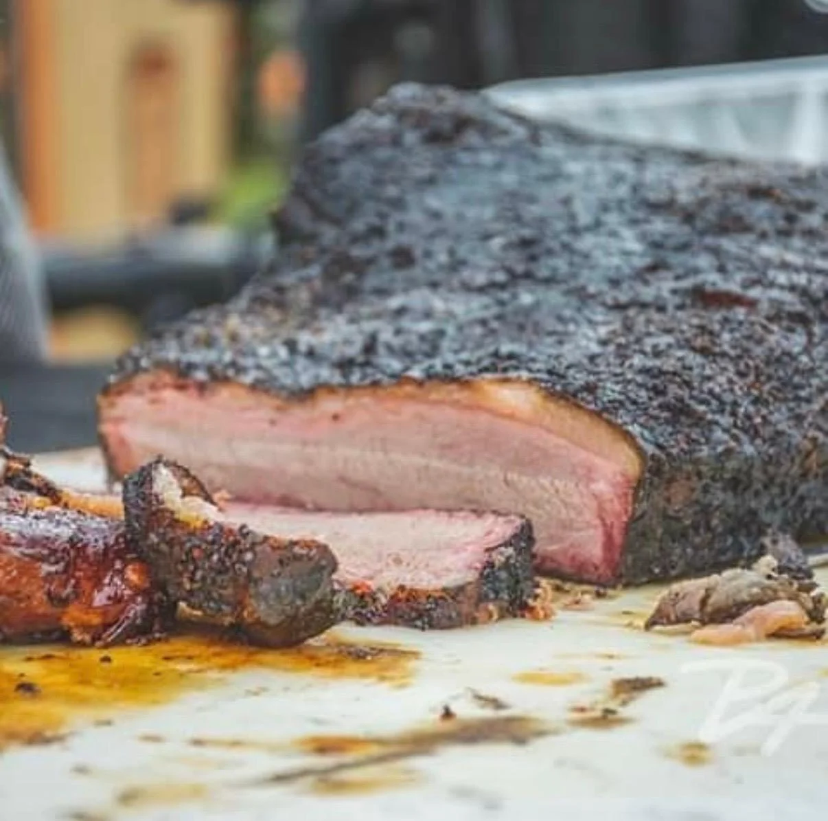 Smoked brisket with a rich bark and tender slices