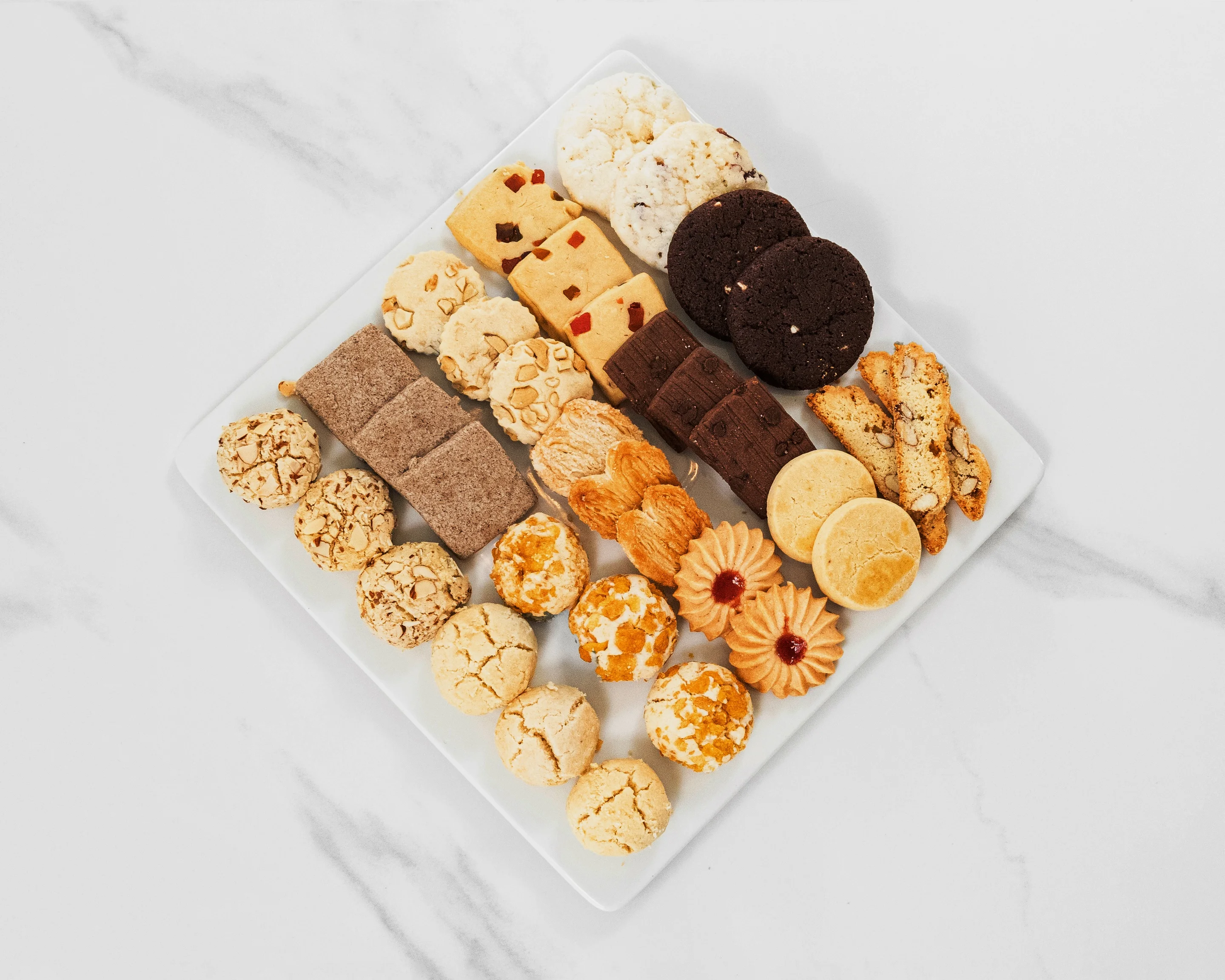 Assorted international cookies on a white platter