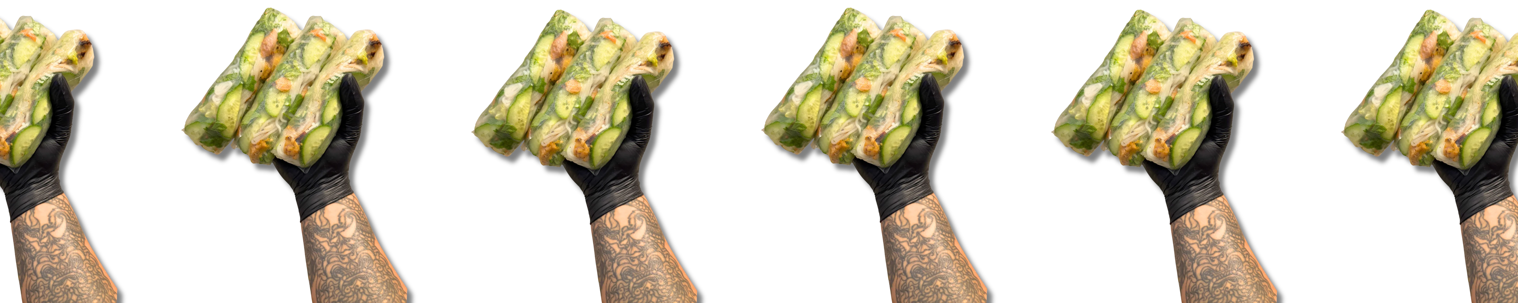 Fresh Vietnamese spring rolls held in a gloved hand