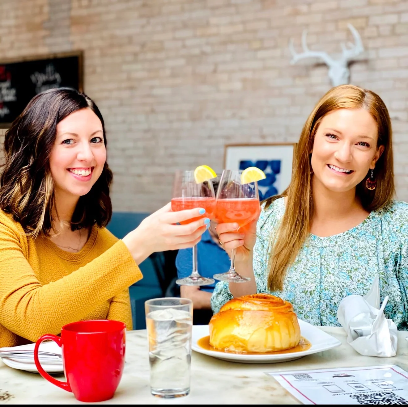 Cheers with cocktails in a cozy restaurant setting