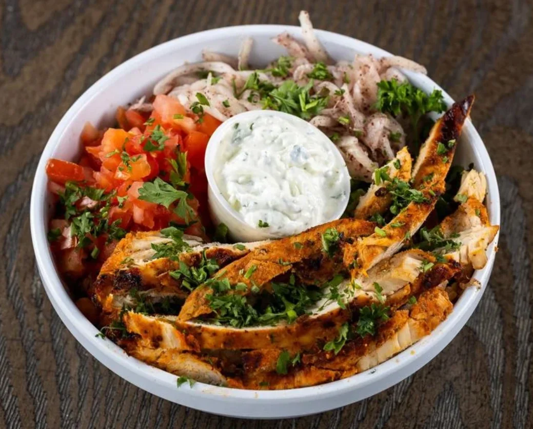 Delicious shawarma platter with fresh vegetables and sauces