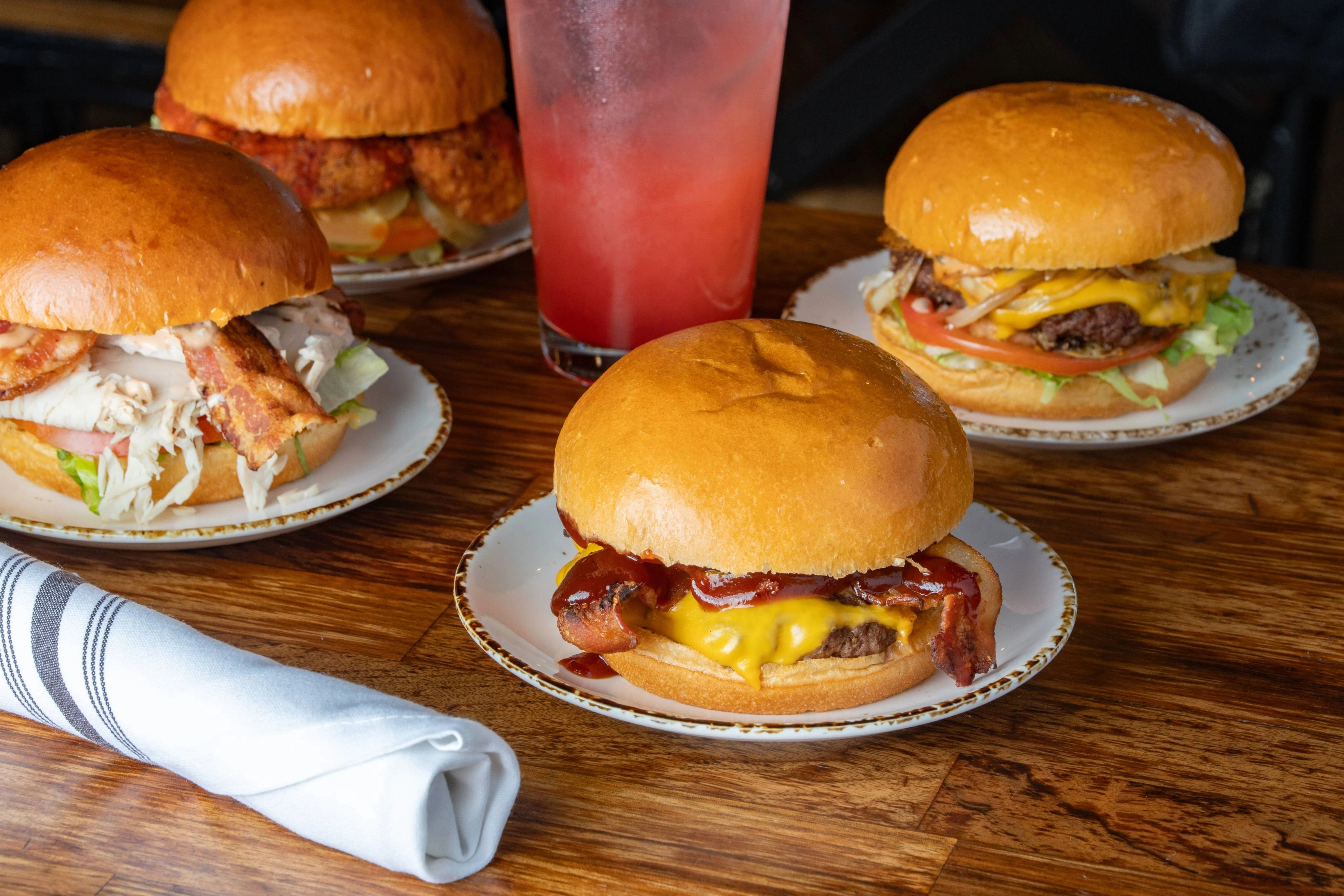 Gourmet sliders with fries on a wooden platter