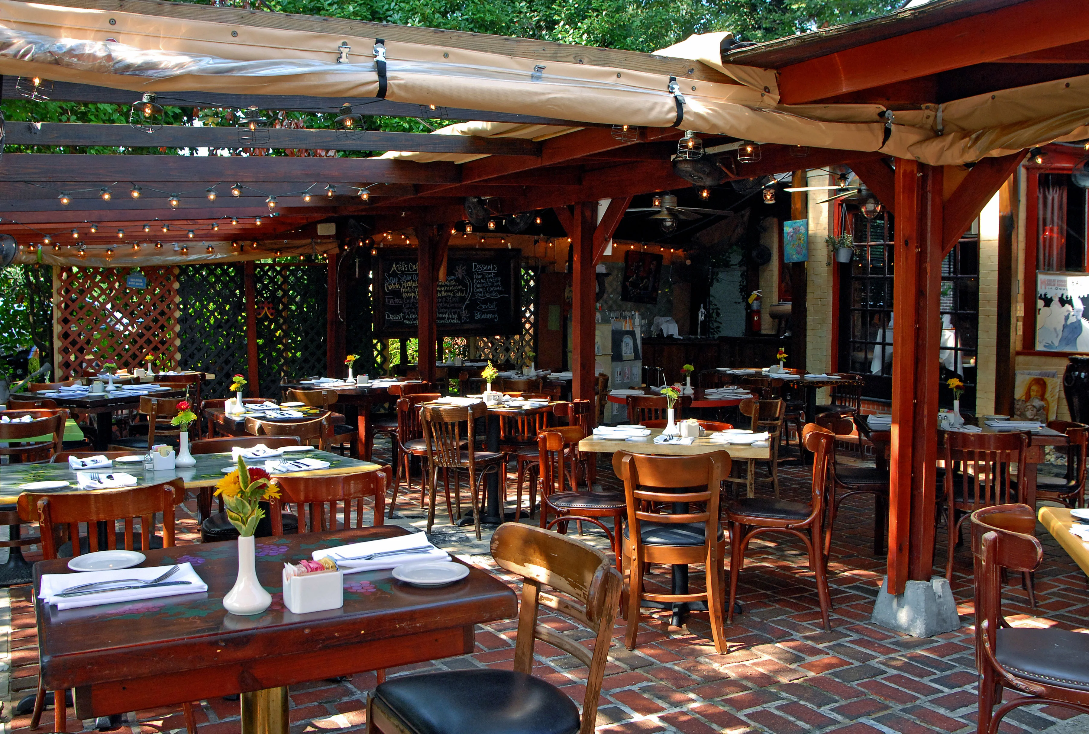Charming outdoor dining area with wooden tables and string lights