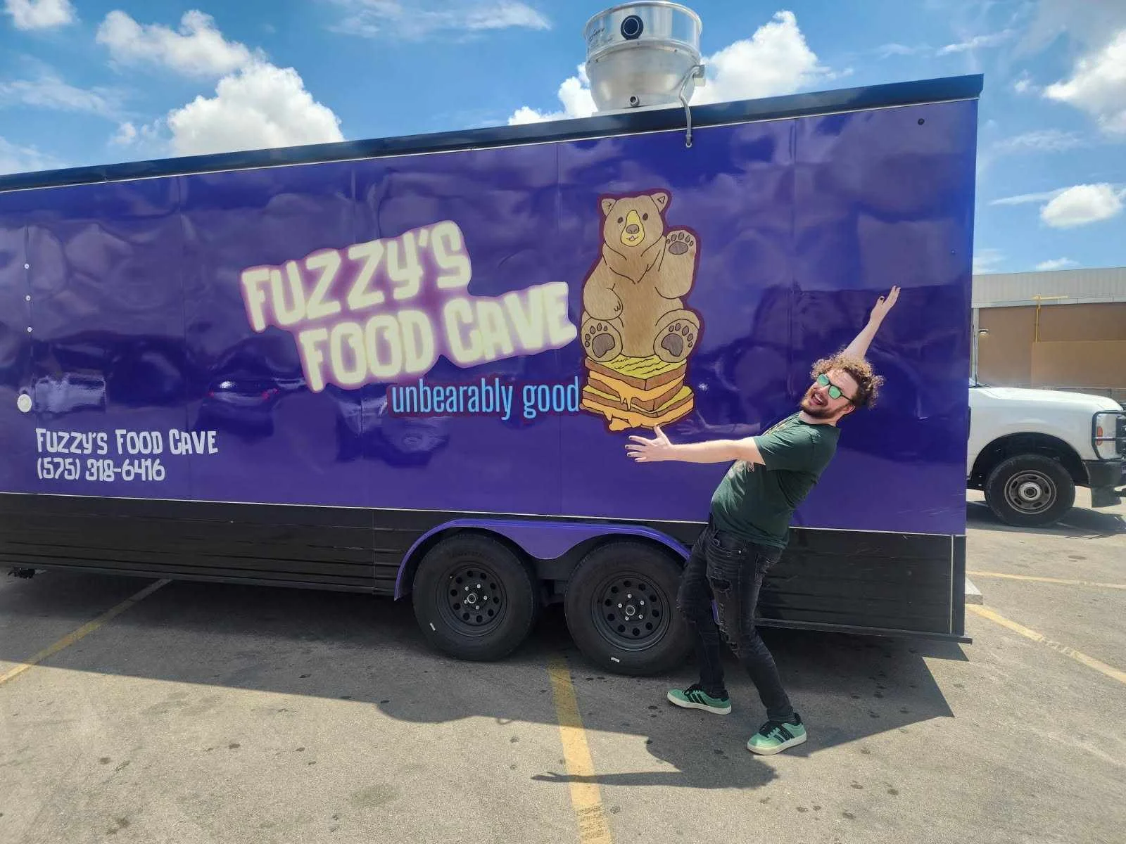 Food truck featuring Fuzzy's Food Cave with a bear logo