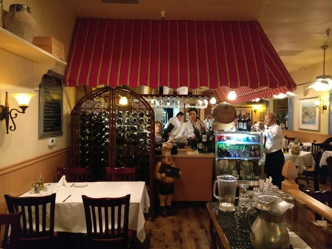 Cozy restaurant interior with wine display and attentive staff