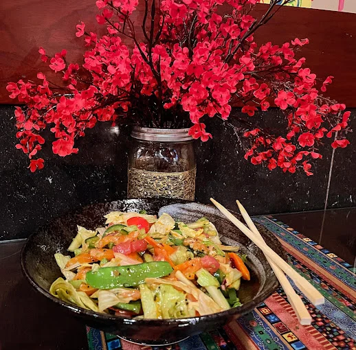 Colorful vegetable stir-fry in a black bowl