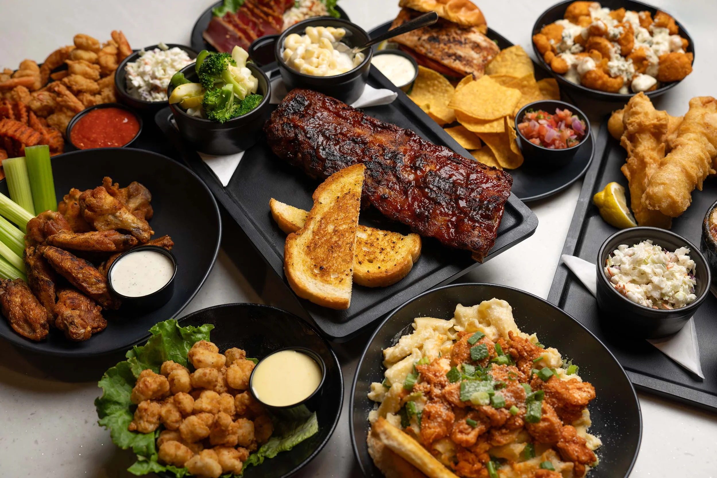 Platter of American barbecue ribs with sides and appetizers