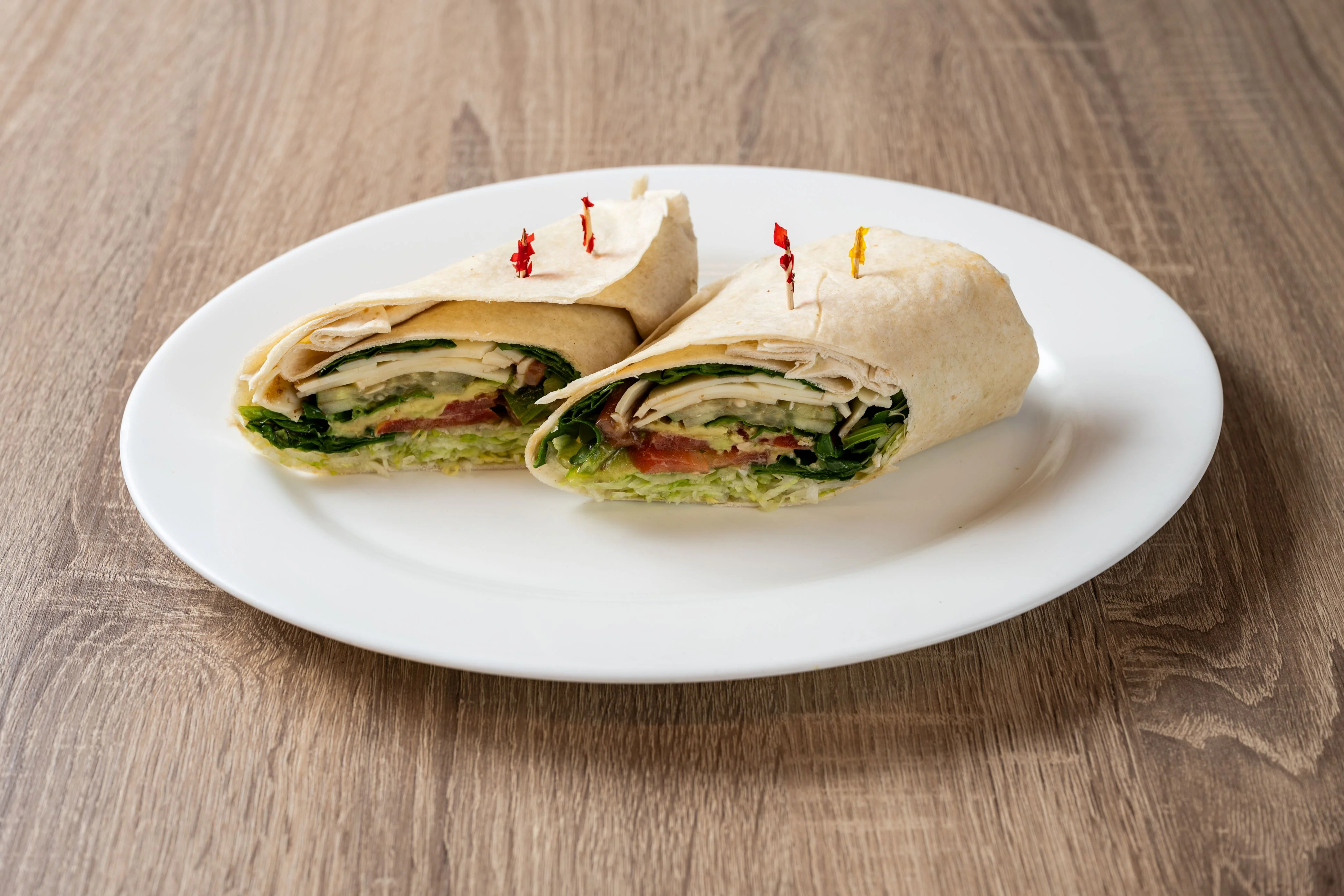 Delicious deli sandwich with fresh ingredients on a wooden table.