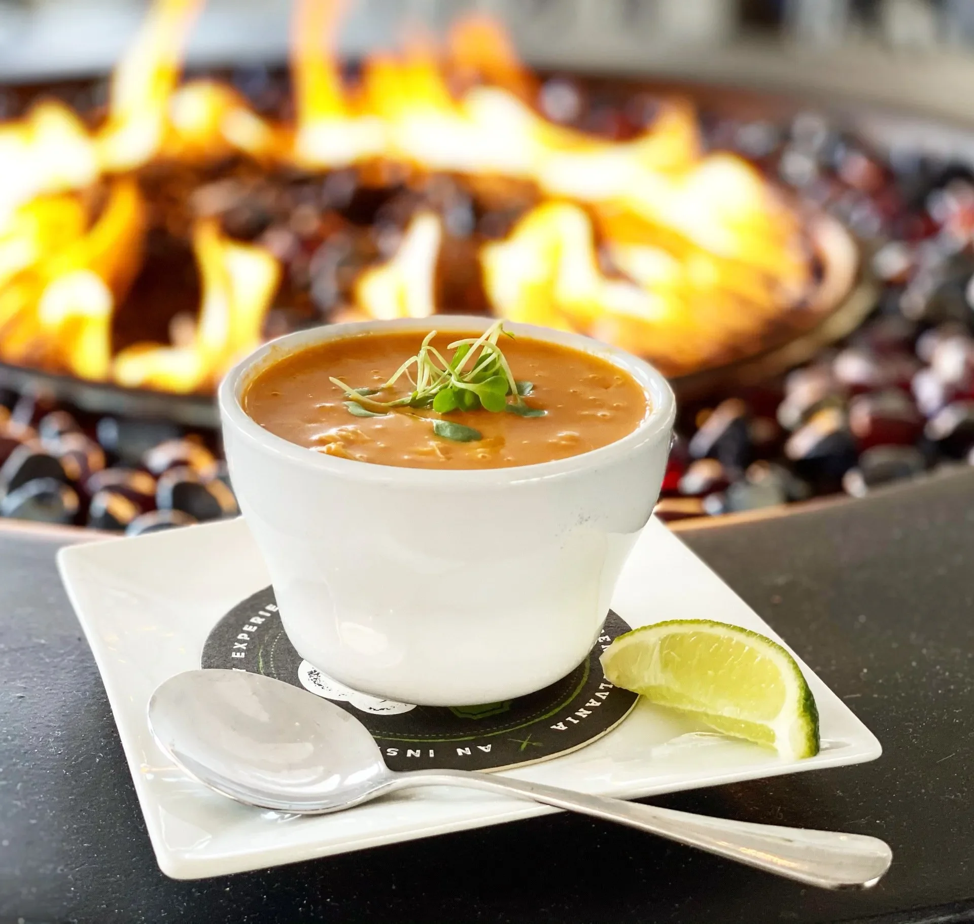 Bowl of Mexican tortilla soup garnished with herbs