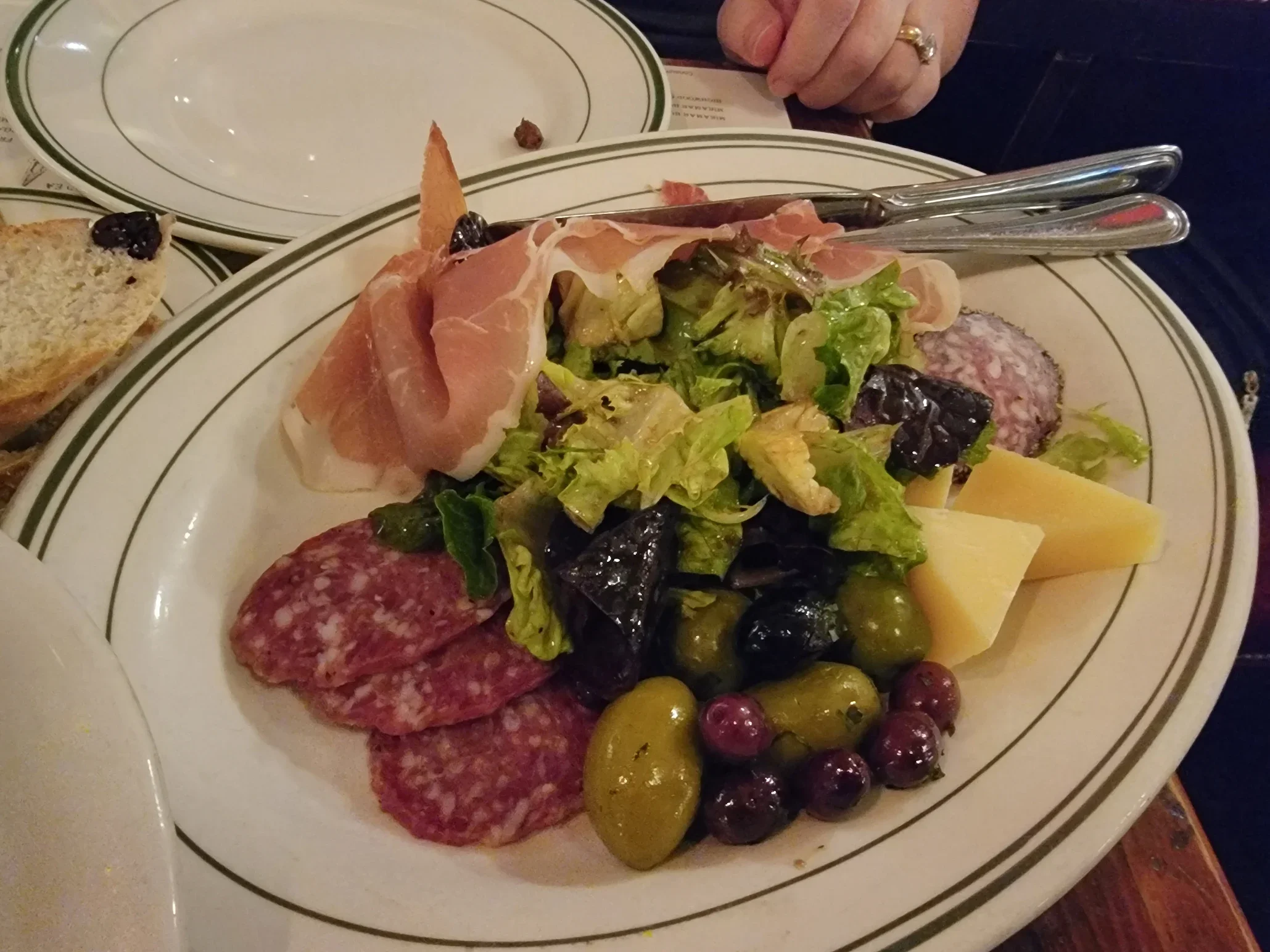 Italian antipasto platter with cured meats, cheese, and fresh greens