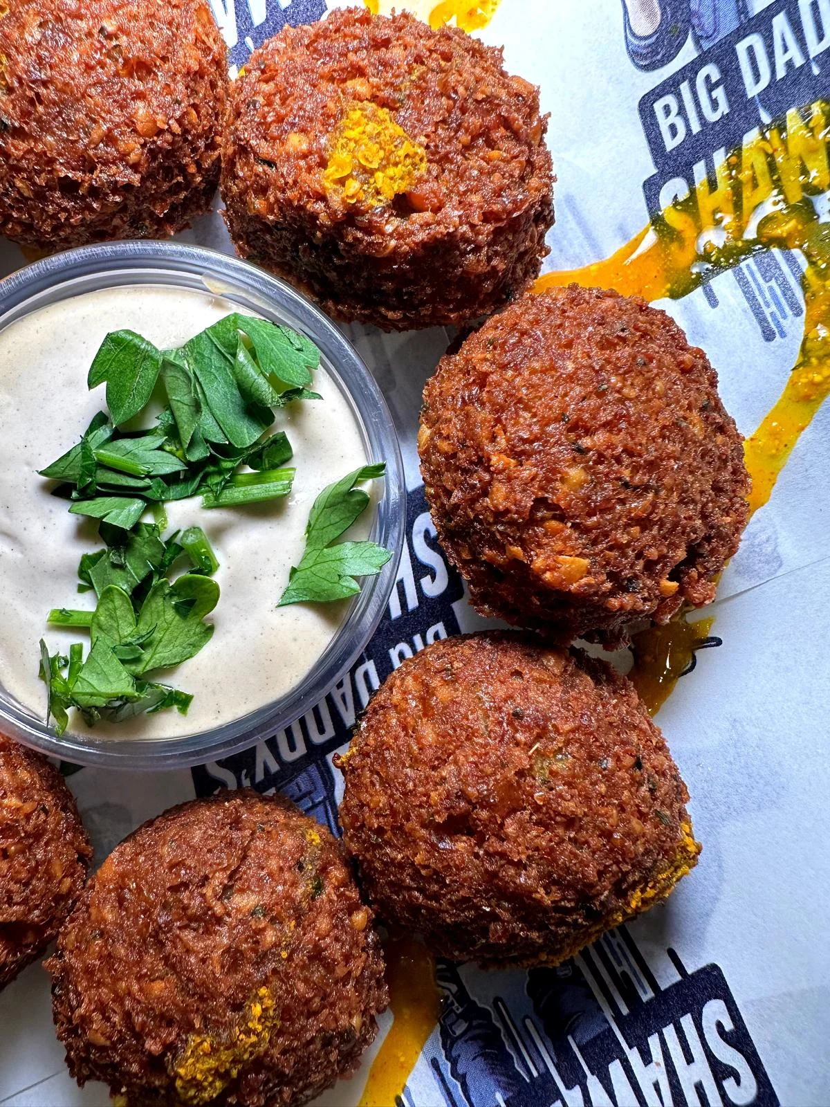 Crispy falafel served with tahini sauce and fresh herbs