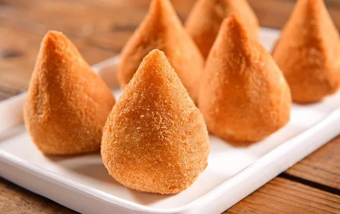 Crispy Brazilian coxinhas on a white plate