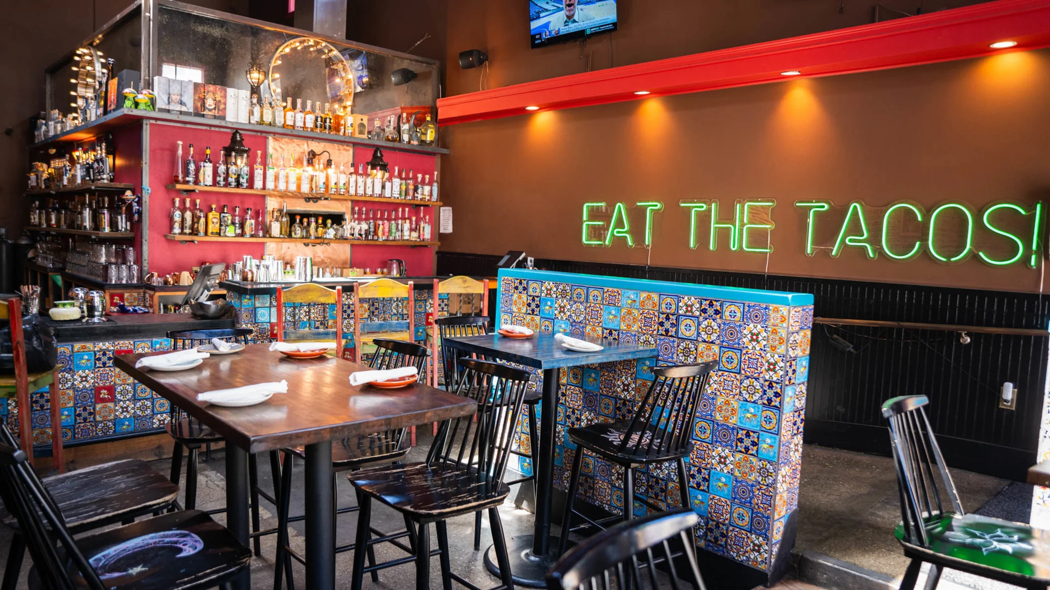 Vibrant restaurant interior with colorful decor and neon sign