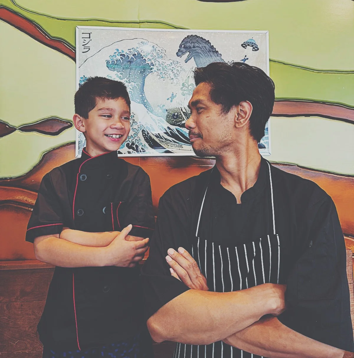 Chefs smiling together in a vibrant restaurant setting